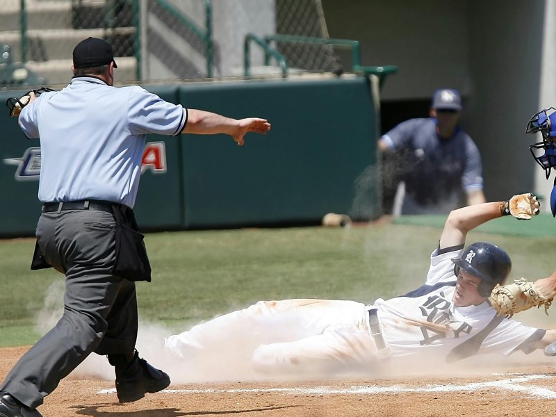 Umpire calling safe at home plate